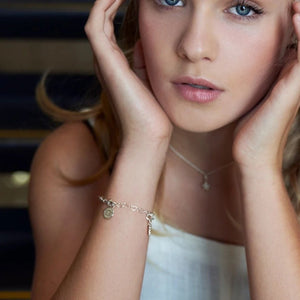 Children's Charm Bracelet in sterling silver, worn by Tween girl with her hands touching her face